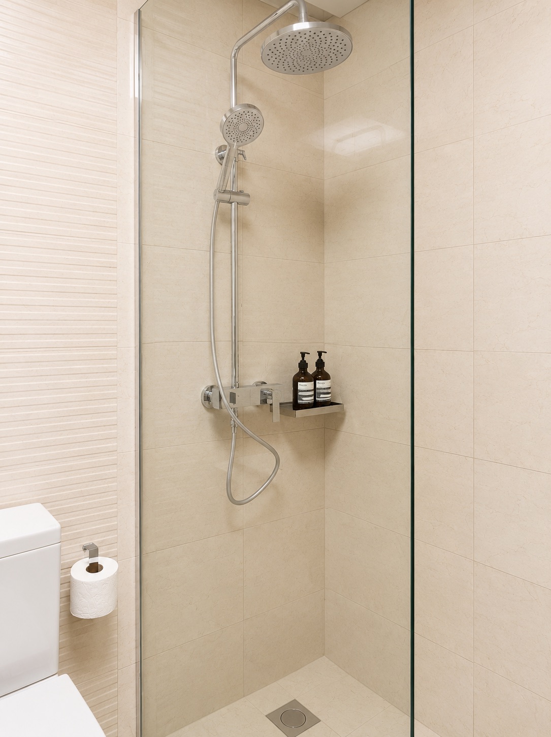 Glass walk-in shower with overhead rain shower